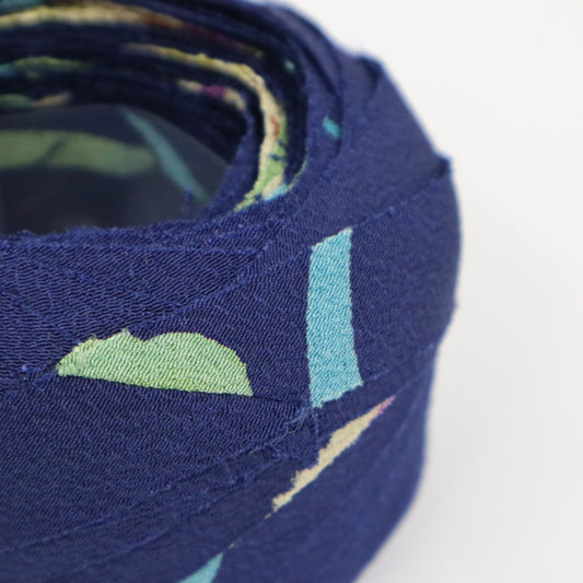 Dark blue with floral and leaf patterns in yellow-green, light blue, white, and purple (Y02312006)