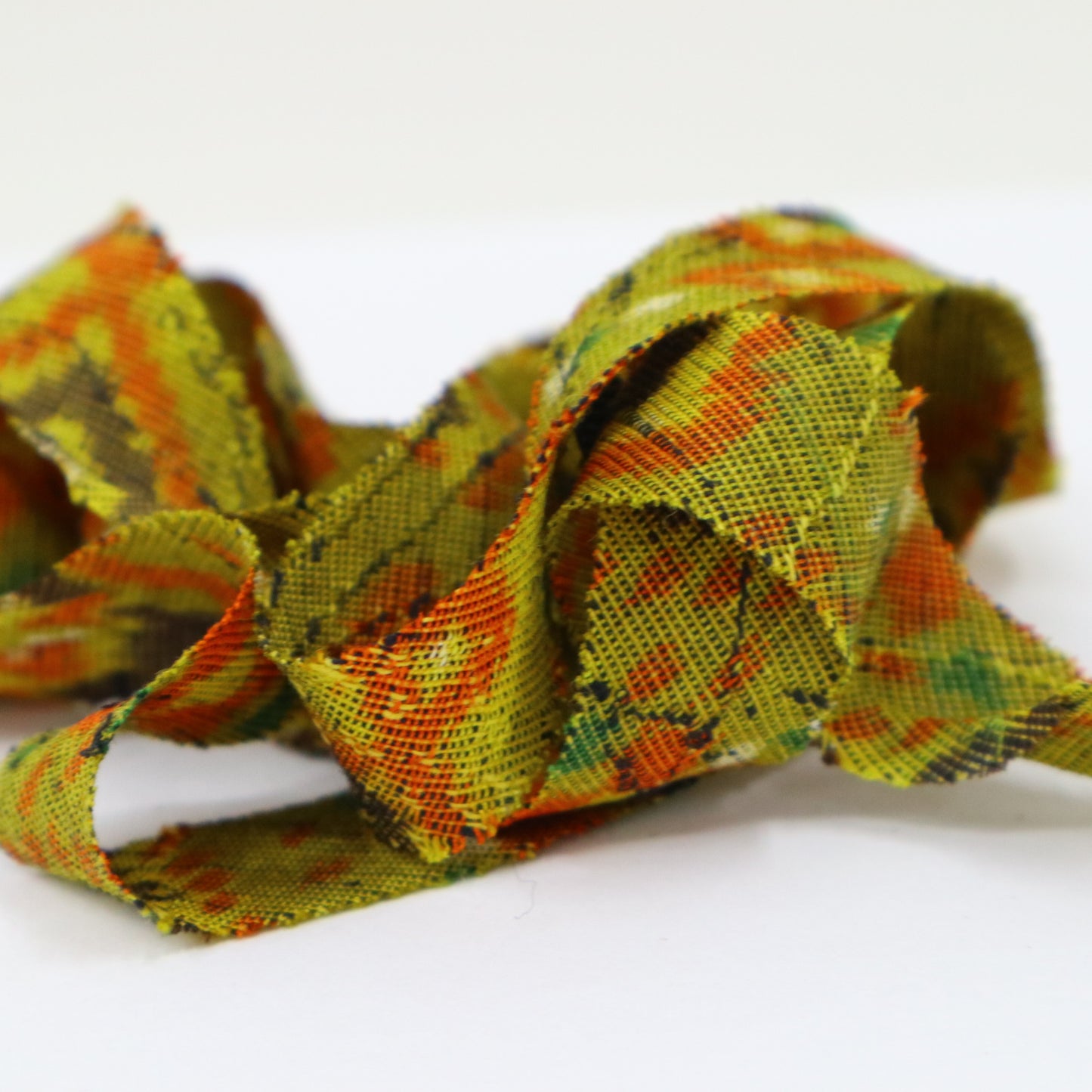 Mustard green with orange, yellow, green, brown, and white geometric pattern, interwoven (Y02405005)