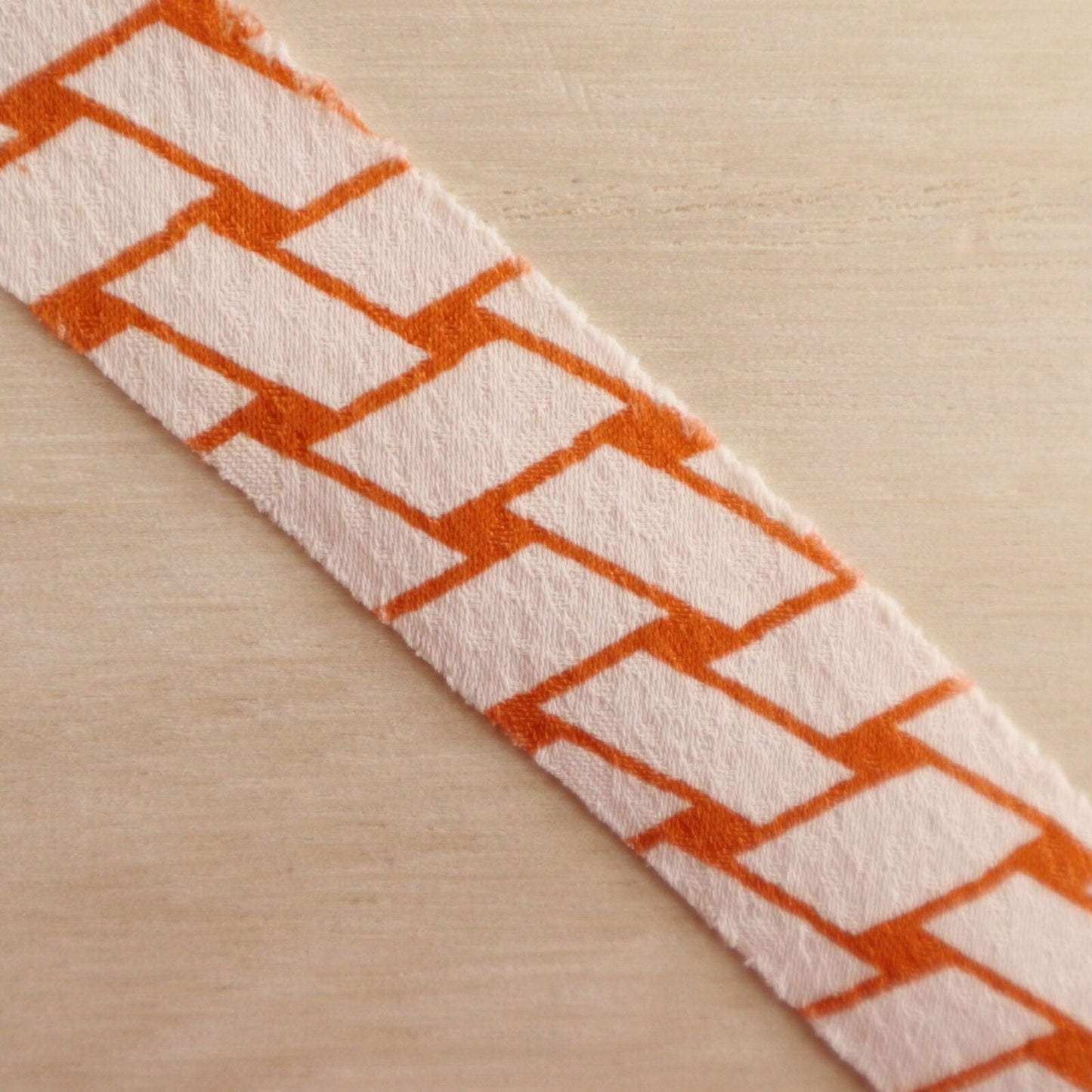 Orange wickerwork pattern on a white background with autumn leaves, plum and crepe (Y02008060)