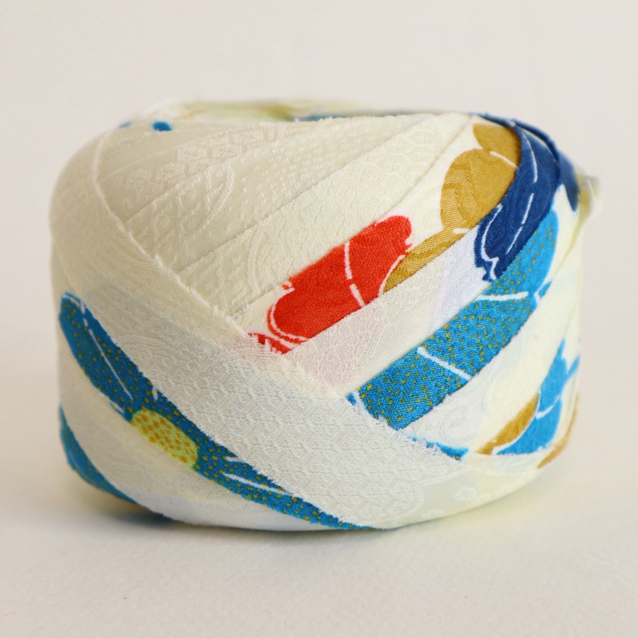 Light cream with red, green, blue, and yellow floral pattern, synthetic fiber (Y02601004)