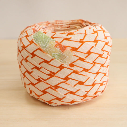 Orange wickerwork pattern on a white background with autumn leaves, plum and crepe (Y02008060)