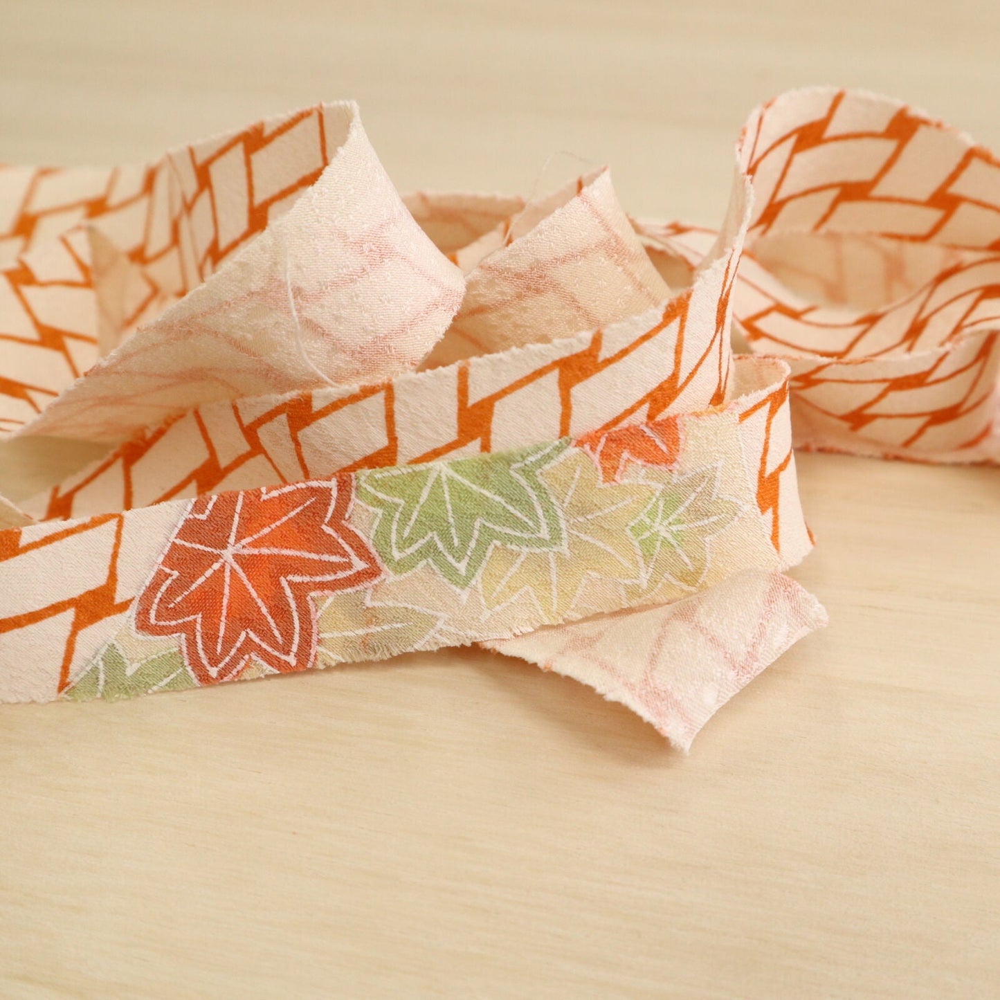 Orange wickerwork pattern on a white background with autumn leaves, plum and crepe (Y02008060)