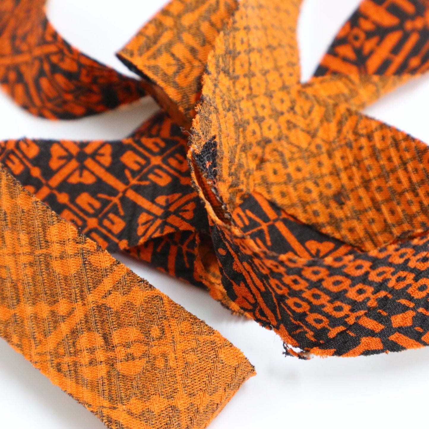 Orange pique and rhombus pattern on black, crepe (Y02009109)